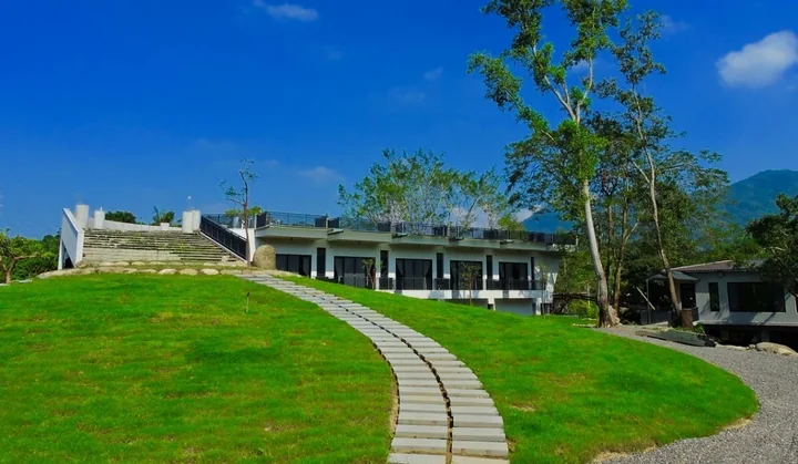 A curved path across the lawn behind the wellness center